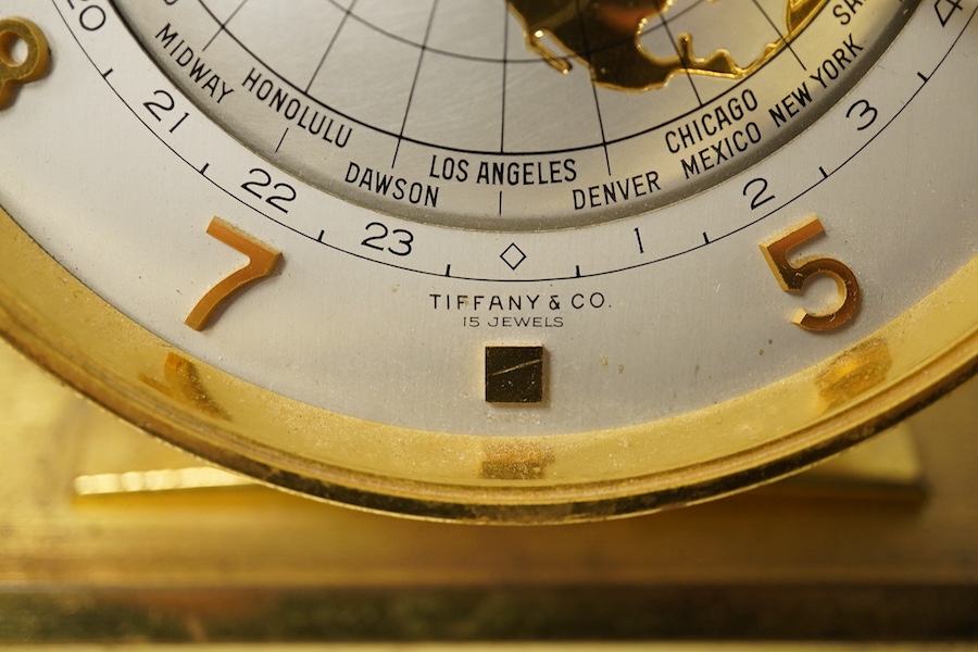 Tiffany and Co gilt metal ‘world’ alarm clock,15.5cm high. Condition - wear to lacquered finish, clock untested if working.